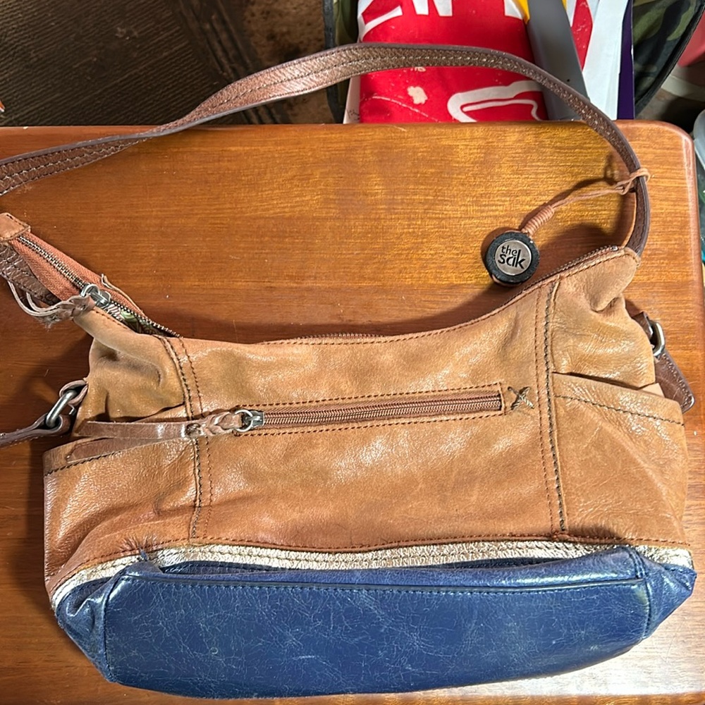 13x8” with 4” gusset The Sak non adjustable strap brown/navy blue bag. 2